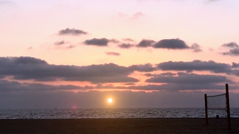 A Flashing UFO Over a Beach Sunset