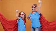 Young girl and her mother pretending to fly as superheroes [131899457] | 写真素材・ストックフォトのアフロ