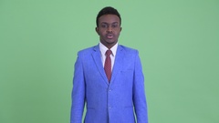 Serious young African businessman with stop gesture [133368892] | 写真素材・ストックフォトのアフロ 