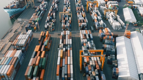 Cargo containers in port, aerial top down view. Freight ship unloading