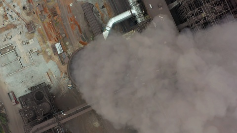 Aerial view. Dirty smoke and smog from pipes of steel factory and blast furnaces