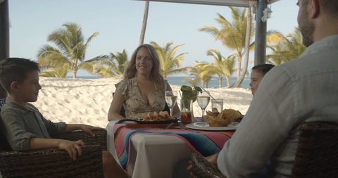 Server Brings Meal to Family at Beach Restaurant Kids