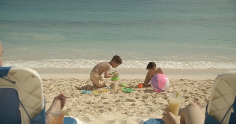 Family Fun on the Beach, Kids Making Sand Castles, Parents Watching