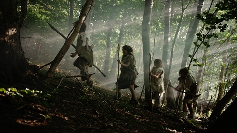 Tribe of Hunter-Gatherers Wearing Animal Skin Holding Stone Tipped Tools