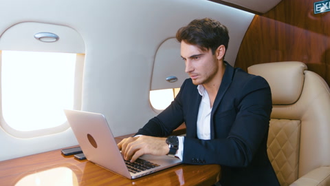 Successful millionere man wearing classical suit using laptop. Traveling in