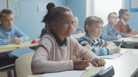 Elementary Classroom of Diverse Children Listening Attentively to their Teacher