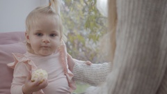 Portrait of little cute Caucasian girl in pink blouse eating … [130234838] | 写真素材・ストックフォトのアフロ