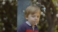 portrait of a little boy sucking lollipop. shot in slow motion [130234459] | 写真素材・ストックフォトのアフロ 