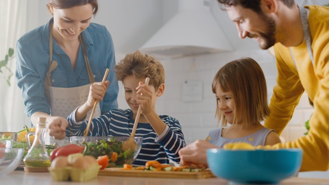 In Kitchen: Family of Four with Little Children Cooking Together Healthy Dinner.