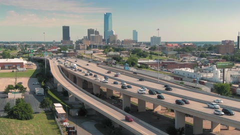 Aerial: Oklahoma City freeway traffic & downtown, USA