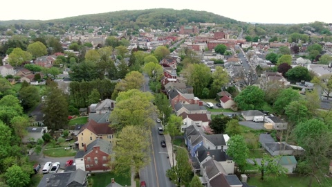 Aerial dolly shot above anytown USA, Small Town America reveals houses,