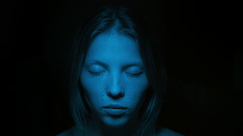 Close up portrait woman angry in blue light, effect burnt film. Woman screaming