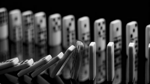 Domino effect: two rows of dominos falling in slow motion,150 fps