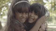 Closeup portrait of Latin girls hugging each other and smiling [147147744] | 写真素材・ストックフォトのアフロ