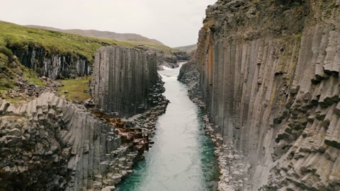 Aerial: Studlagil volcanic basalt Canyon Jokulsa Bru river Highlands of Iceland