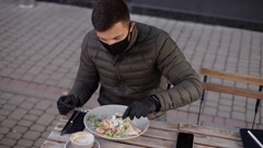 Proces of Man pulled off protective mask for eating. Man in … [149380208] | 写真素材・ストックフォトのアフロ