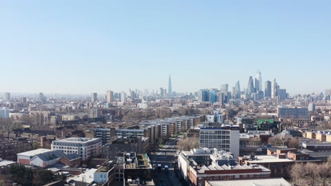 Rising drone shot of Central London skyline from mile end East sunny day