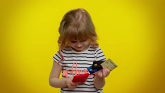 Little teen kid child girl using credit bank cards and smartphone