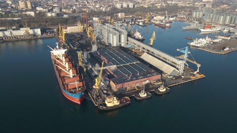 Aerial view of a cargo ship in the port dock Trade Export. Loading and unload