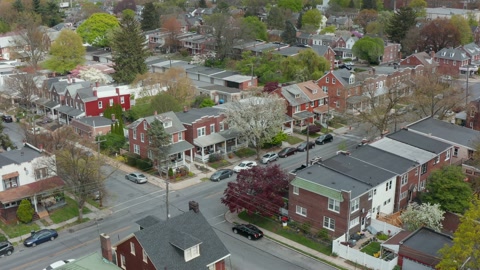 Descending aerial establishing shot of homes in city. Pedestal shot.