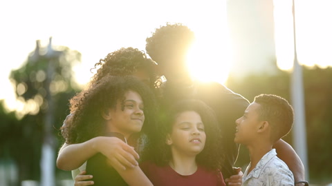 Family embrace love and hug. Brazilian parents hugging children