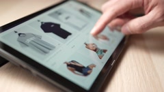 Shopping For Fashion Clothing On a Tablet Touch Screen Closeup [164649911] | 写真素材・ストックフォトのアフロ