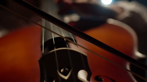 Musician plays classical music with bow on cello, closeup. Bow plays music on