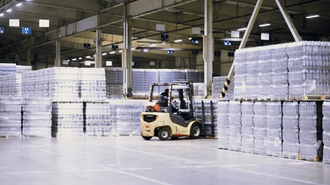 loader on the background of a huge industrial food warehouse with plastic PET