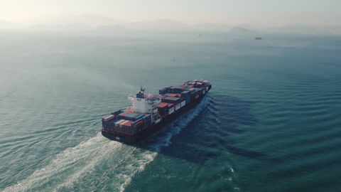 Aerial view of international containers cargo ship in open ocean.