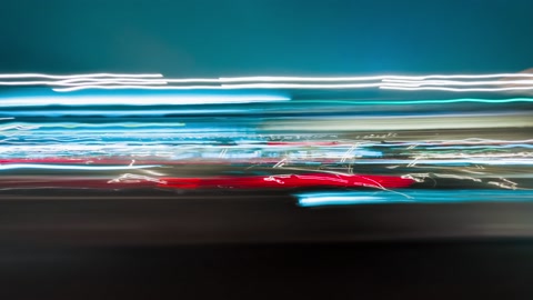 Bright motion timelapse of a speedy night drive in a big city.