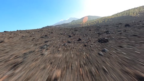 FPV drone flying through a volcanic rocky landscape national park. Rough stone