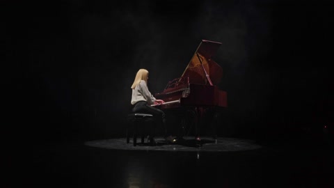 Woman playing classical piano concerto