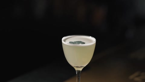 Beautiful cocktail with fresh mint petal on stylish bar.