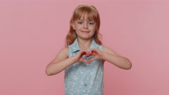 Smiling preteen child girl kid makes heart gesture demonstrates … [194145855] | 写真素材・ストックフォトのアフロ 