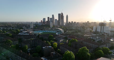 Large sports venue among classical multistorey tenant houses in city