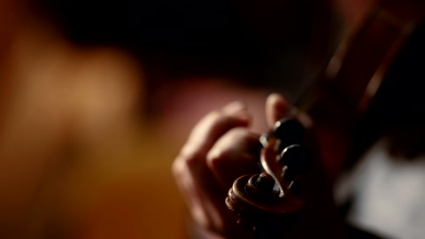 Close-up of a professional violinist playing classical music in an orchestra