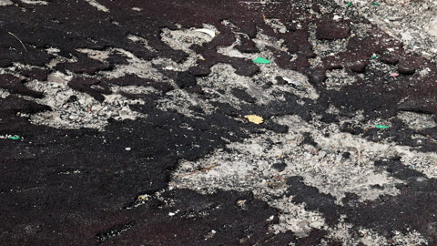 War in Ukraine. Funnel from the explosion in the asphalt