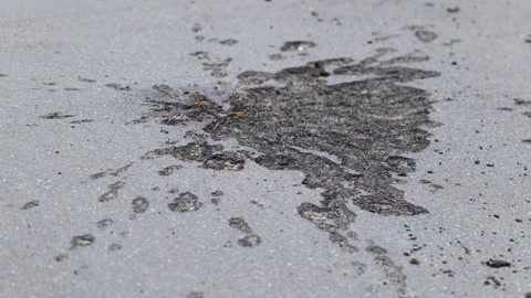 War in Ukraine. A shell explosion crater in the asphalt