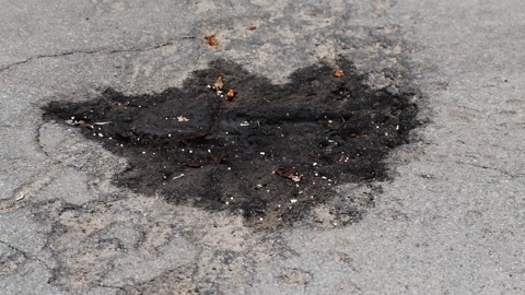 War in Ukraine. A shell explosion crater in the asphalt