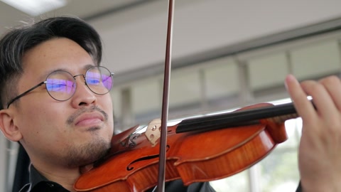 asian men playing the violin classical instrument.