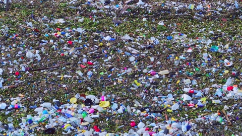 Ocean waves full of plastic trash, close-up sea pollution, world