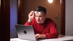 closeup tired programmer, freelancer with poor eyesight working … [243059223] | 写真素材・ストックフォトのアフロ