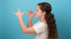 Profile portrait of preteen girl child playing with hands near … [243947882] | 写真素材・ストックフォトのアフロ