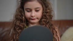 Close-up. A beautiful preteen girl in a green dress straightens … [244963261] | 写真素材・ストックフォトのアフロ