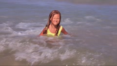 Preteen girl in a swimsuit have fun swimming in the sea and … [249706744] | 写真素材・ストックフォトのアフロ